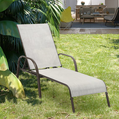 Adjustable Chaise Lounge Chair for Patio in gray color, featuring a foldable design and five adjustable positions, placed on a lush green lawn, perfect for outdoor relaxation.