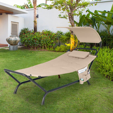 Beige Patio Hanging Chaise Lounge Chair with Canopy, Cushion, and Storage Bag - Comfortable Outdoor Relaxation, set in a lush garden setting, perfect for outdoor leisure and relaxation.