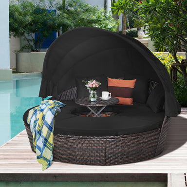 Spacious Black Rattan Round Daybed featuring a Retractable Canopy and Adjustable Table, set beside a serene pool for ultimate relaxation.