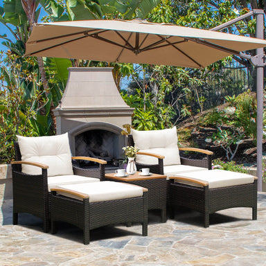 5-Piece Patio Conversation Set with Cushions, Coffee Table & 2 Multi-Purpose Ottomans, featuring two chairs and a coffee table under an umbrella in a vibrant outdoor setting.