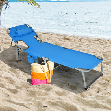 5-Position Adjustable Folding Beach Lounge Chair with Removable Pillow - Blue set up on the sandy beach with a colorful tote bag nearby, perfect for sunbathing and relaxation.