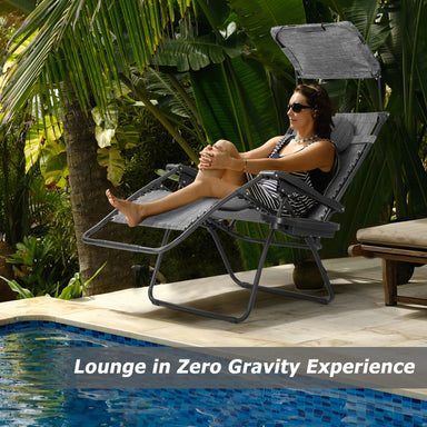 A woman lounging in a Dream Yard Oasis Folding Recliner Lounge Chair with Canopy by the pool, showcasing zero gravity experience and comfort.