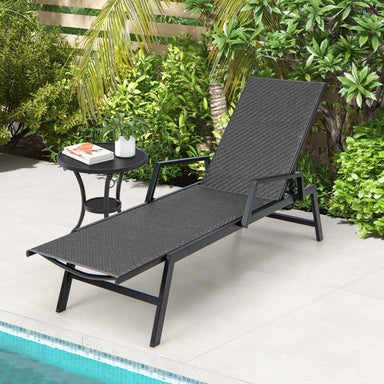 Brown Outdoor Rattan Chaise Lounge Chair with 5-Position Backrest and Armrests placed by a pool surrounded by lush greenery, perfect for backyard relaxation.