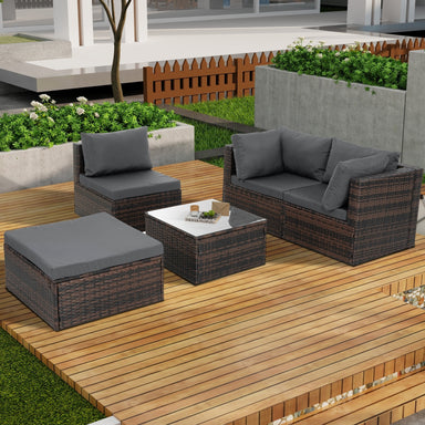 Dream Yard Oasis™ 5-Piece Brown PE Wicker Patio Furniture Set for 4, showcasing the arrangement of a sofa, two chairs, and a coffee table in a sunny backyard.