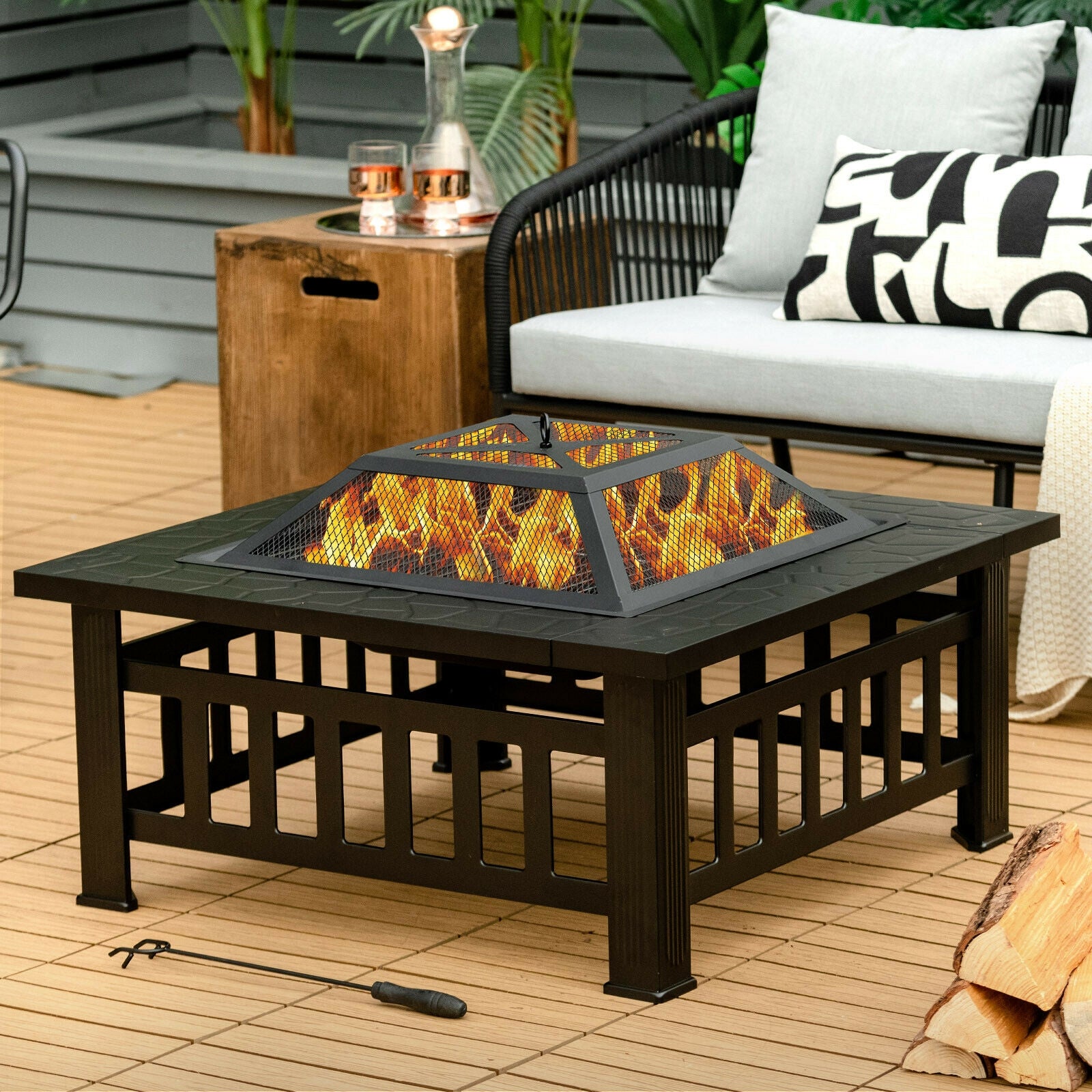 32-Inch 3-In-1 Outdoor Square Fire Pit Table with BBQ Grill, Ice Bucket & Rain Cover featuring a cozy fire burning inside a stylish fire pit, surrounded by comfy outdoor seating.