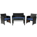 Stylish 4-Piece Navy Cushioned Rattan Patio Furniture Set displayed with a loveseat, two armchairs, and a coffee table, ideal for relaxation.