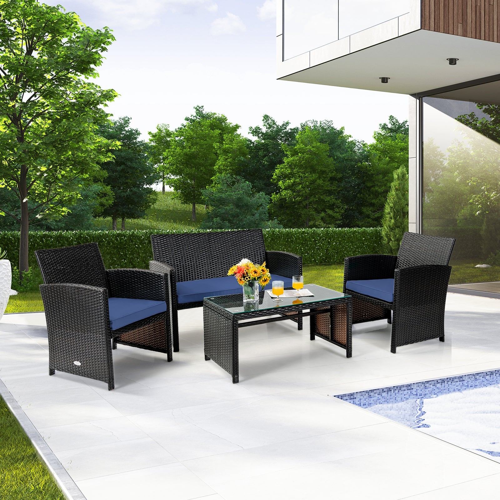 4-Piece Navy Cushioned Rattan Patio Furniture Set with Coffee Table for Indoor/Outdoor Use in a sunny backyard setting, featuring a cozy loveseat, two single chairs, and a stylish coffee table.