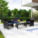 4-Piece Navy Cushioned Rattan Patio Furniture Set with Coffee Table for Indoor/Outdoor Use in a sunny backyard setting, featuring a cozy loveseat, two single chairs, and a stylish coffee table.