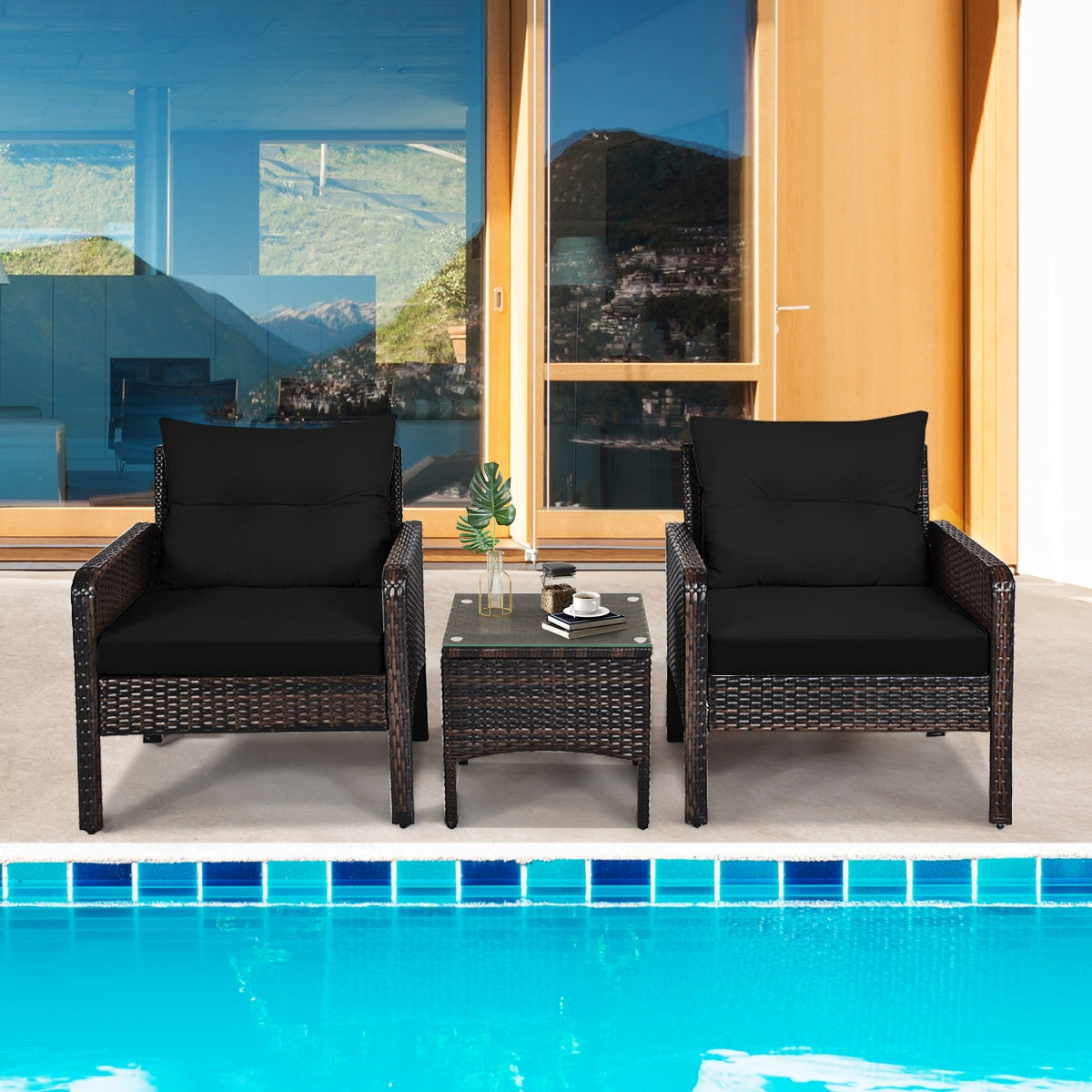 3-Piece Black Rattan Outdoor Patio Conversation Set with Cushions & Glass Table perfect for poolside lounging, highlighting modern outdoor decor.