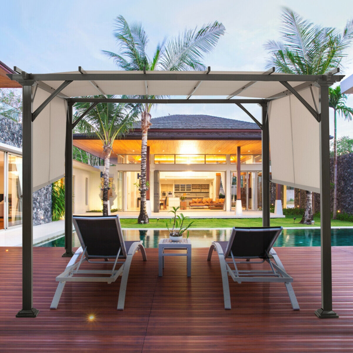 10x10 Metal Frame Patio Furniture Shelter with Adjustable Canopy - Weather-Resistant Beige Gazebo set up by a pool with lounge chairs and lush palm trees in the background.
