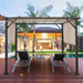 10x10 Metal Frame Patio Furniture Shelter with Adjustable Canopy - Weather-Resistant Beige Gazebo set up by a pool with lounge chairs and lush palm trees in the background.