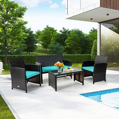 4-Piece Cushioned Patio Rattan Furniture Set in Green featuring a loveseat, two chairs, and a coffee table in a stylish outdoor setting by the pool.