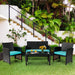 4-Piece Cushioned Patio Rattan Furniture Set in Green arranged in an outdoor setting surrounded by lush greenery, perfect for relaxation.