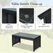 Close-up of the heavy-duty construction and tempered glass top of the coffee table in the Dream Yard Oasis 4-Piece Rattan Patio Furniture Set with Weather-Resistant Cushions & Tempered Glass Table - Turquoise.