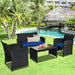 4-Piece Navy Rattan Patio Furniture Set with Weather-Resistant Cushions & Tempered Glass Table, featuring a loveseat, two armchairs, and a coffee table set in a lush outdoor garden setting by a pool.