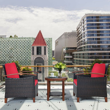 3 Piece Solid Wood Frame Patio Rattan Furniture Set with Red Cushions showcased on a balcony, featuring stylish chairs and a coffee table, perfect for outdoor relaxation.
