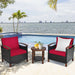 The 3 Piece Solid Wood Frame Patio Rattan Furniture Set with Red Cushions set by a pool, perfect for outdoor relaxation.