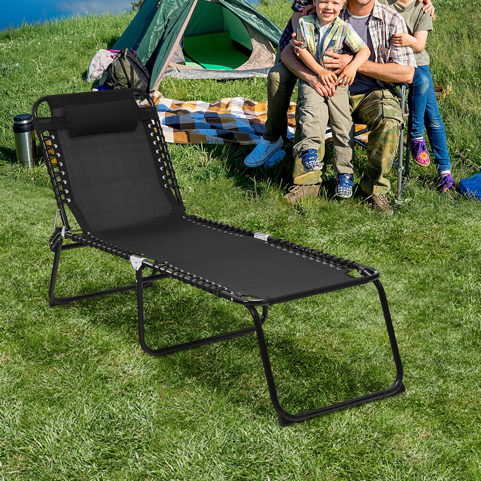 Adjustable Folding Beach Lounge Chair with Pillow, ideal for outdoor adventures, set up in a green camping area, showcasing family-friendly comfort.