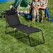 Adjustable Folding Beach Lounge Chair with Pillow, ideal for outdoor adventures, set up in a green camping area, showcasing family-friendly comfort.