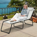 Gray Folding Chaise Lounge Chair with Adjustable Backrest, Pillow, and High Load Capacity 265 lbs, designed for comfort and relaxation on a patio with scenic views.