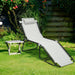 Gray Folding Chaise Lounge Chair with Adjustable Backrest, Pillow, and High Load Capacity 265 lbs placed in a garden setting with greenery.