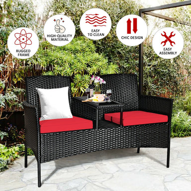 2-Piece Wicker Patio Conversation Set with Removable Cushions & Glass Table - Red, showcasing its rugged frame and user-friendly assembly in a lush garden setting.