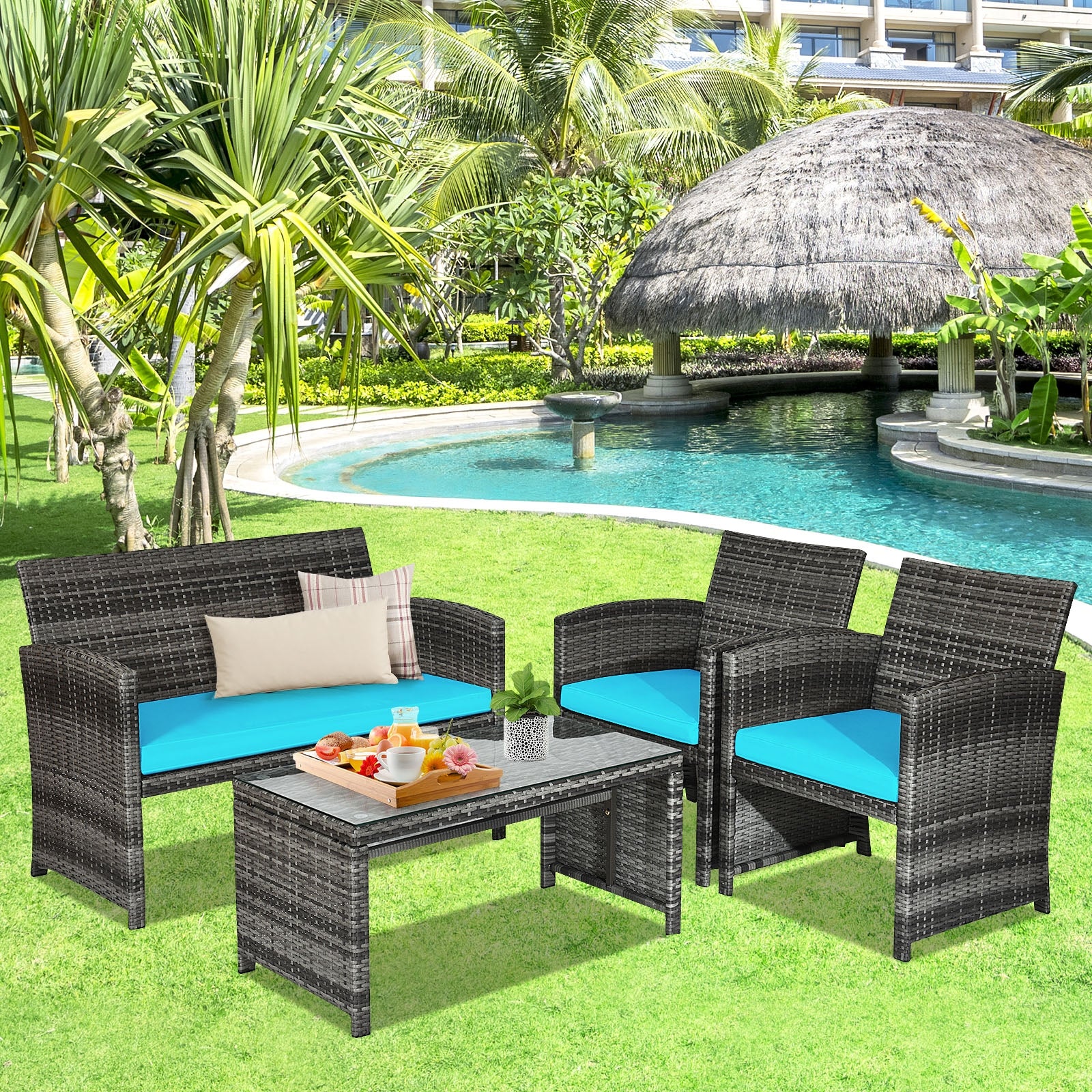 4-Piece Turquoise Rattan Patio Furniture Set with Cushions arranged in a tropical garden with a pool, showcasing a loveseat, two chairs, and a stylish coffee table.