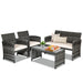 4-Piece White Patio Rattan Furniture Set with Cushioned Sofa and Glass Table - Durable & Stylish featuring a black rattan loveseat, two chairs, and a coffee table perfectly arranged for outdoor relaxation.