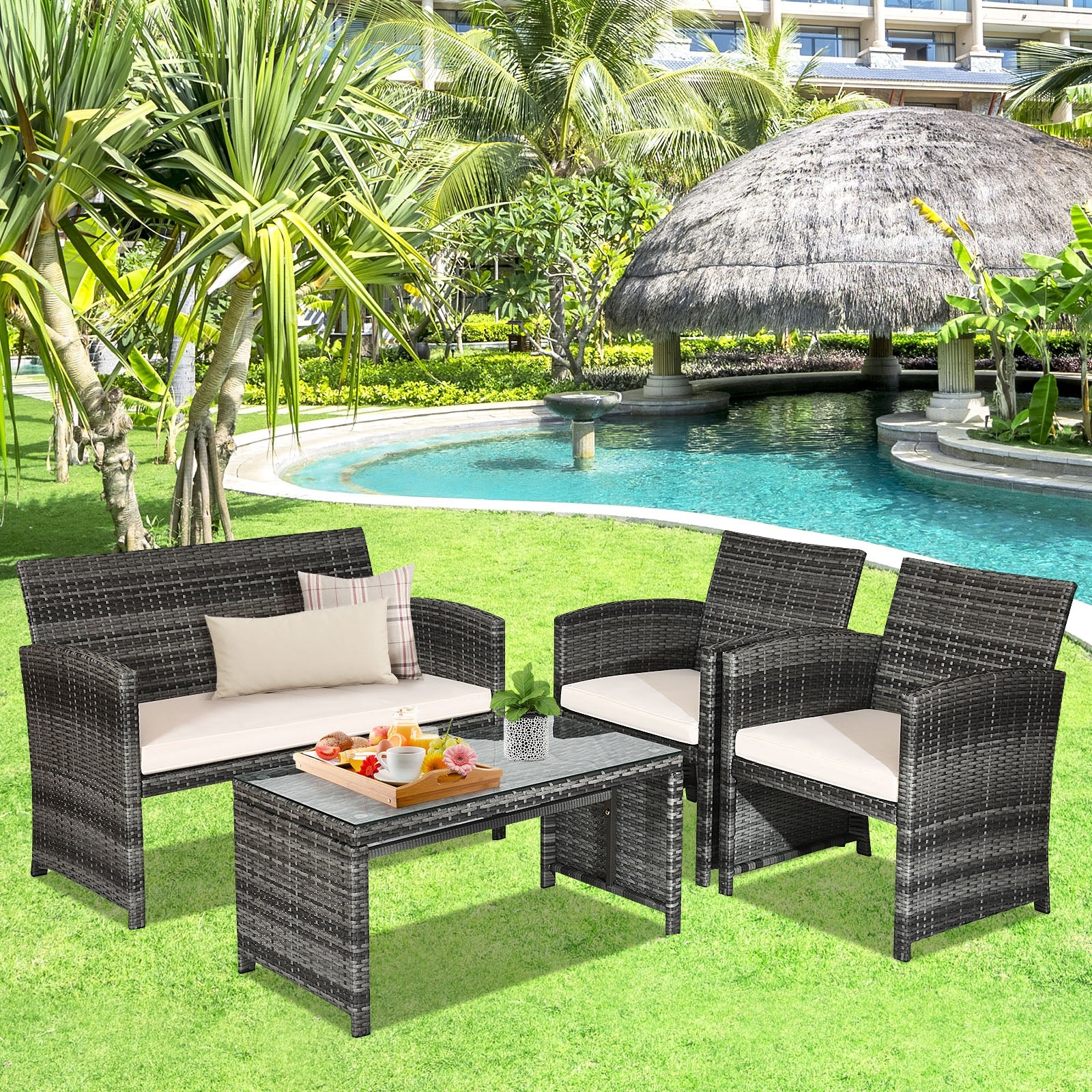 4-Piece White Patio Rattan Furniture Set arranged beautifully in a lush garden setting, perfect for enjoying sunny days.
