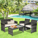 4-Piece White Patio Rattan Furniture Set arranged beautifully in a lush garden setting, perfect for enjoying sunny days.