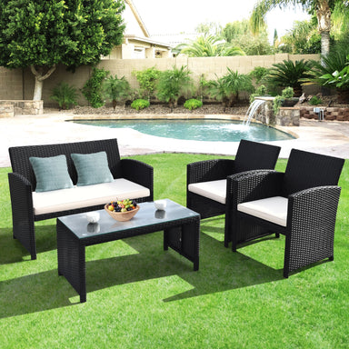 4-Piece Rattan Patio Furniture Set with Weather-Resistant Cushions & Tempered Glass Tabletop arranged in a lush backyard with a pool, featuring a loveseat and two single sofas.