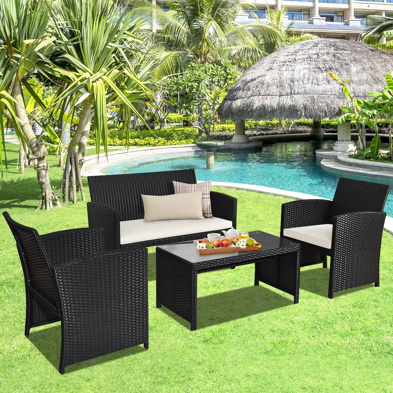 4-Piece Rattan Patio Furniture Set with Weather-Resistant Cushions & Tempered Glass Tabletop arranged around a poolside in a lush garden setting.