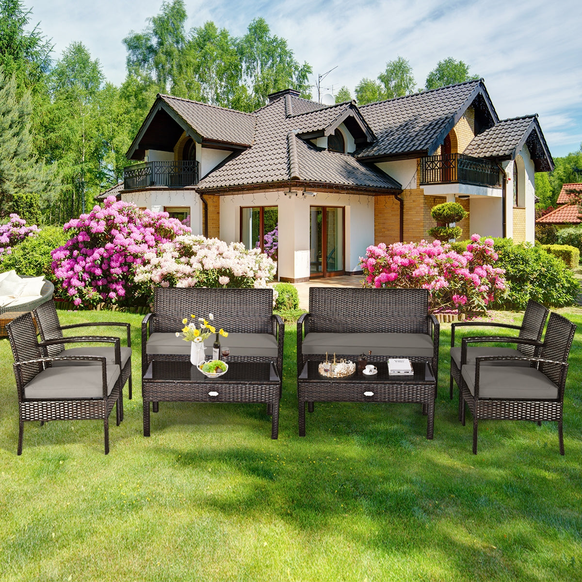 4-Piece Patio Rattan Furniture Set with Cushions, Loveseat, & Table - Brown Outdoor Bliss arranged beautifully in a sunny backyard, perfect for gatherings and leisure.