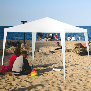 10'x10' Outdoor Canopy Tent with 4 Removable Sidewalls set up on a beach, providing shade for guests.