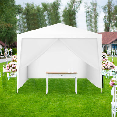 Dream Yard Oasis 10'x10' Outdoor Canopy Tent with 4 Removable Sidewalls set up on a grassy area, featuring an elegant table inside, perfect for outdoor events like weddings or gatherings.