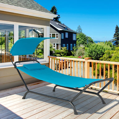 Navy Hanging Chaise Lounge Chair with Canopy, Thick Cushion, Storage Pocket & Anti-Slip Feet, showcased on a sunny patio with a view of greenery.