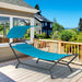 Navy Hanging Chaise Lounge Chair with Canopy, Thick Cushion, Storage Pocket & Anti-Slip Feet, showcased on a sunny patio with a view of greenery.