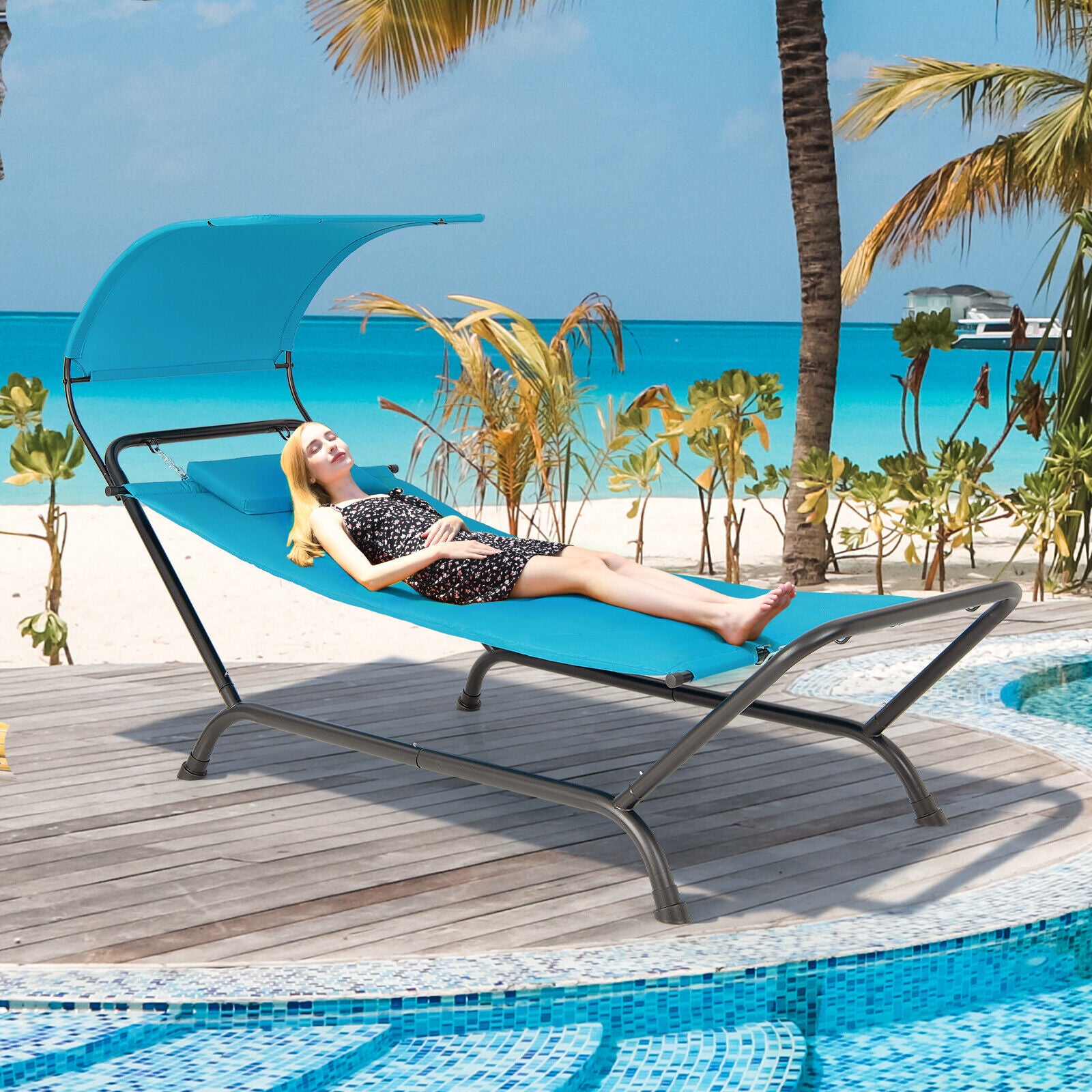 Navy Hanging Chaise Lounge Chair with Canopy, Thick Cushion, Storage Pocket & Anti-Slip Feet, depicted with a model relaxing on the beach, showcasing its comfort and style.