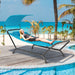 Navy Hanging Chaise Lounge Chair with Canopy, Thick Cushion, Storage Pocket & Anti-Slip Feet, depicted with a model relaxing on the beach, showcasing its comfort and style.