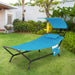 Navy Hanging Chaise Lounge Chair with Canopy, Thick Cushion, Storage Pocket & Anti-Slip Feet in a beautiful outdoor setting, perfect for relaxation and enjoying the sun.
