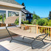 Beige Patio Hanging Chaise Lounge Chair with Canopy, Cushion, and Storage Bag - Comfortable Outdoor Relaxation showcased on a deck with a scenic view.