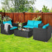 4-Piece Turquoise Patio Rattan Sofa Set with Cushions & Tempered Glass Table in a vibrant outdoor setting with green grass and a wooden fence.