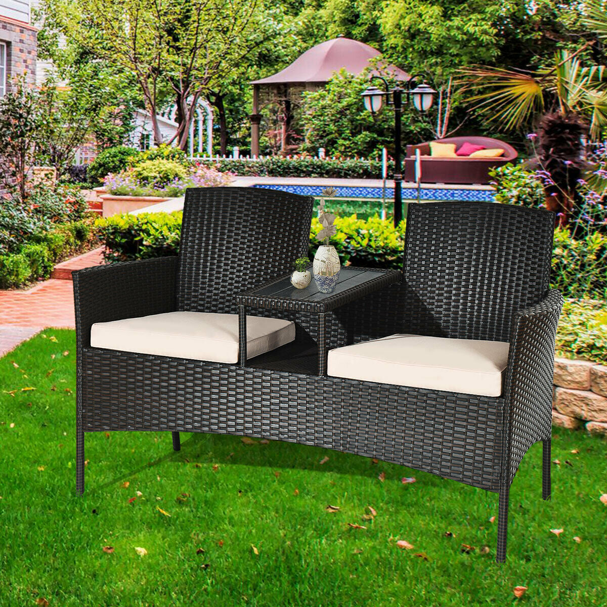 Modern Patio Conversation Set With Coffee Table, Cushions, Rugged PE Rattan, Beige displayed in a lush garden environment.