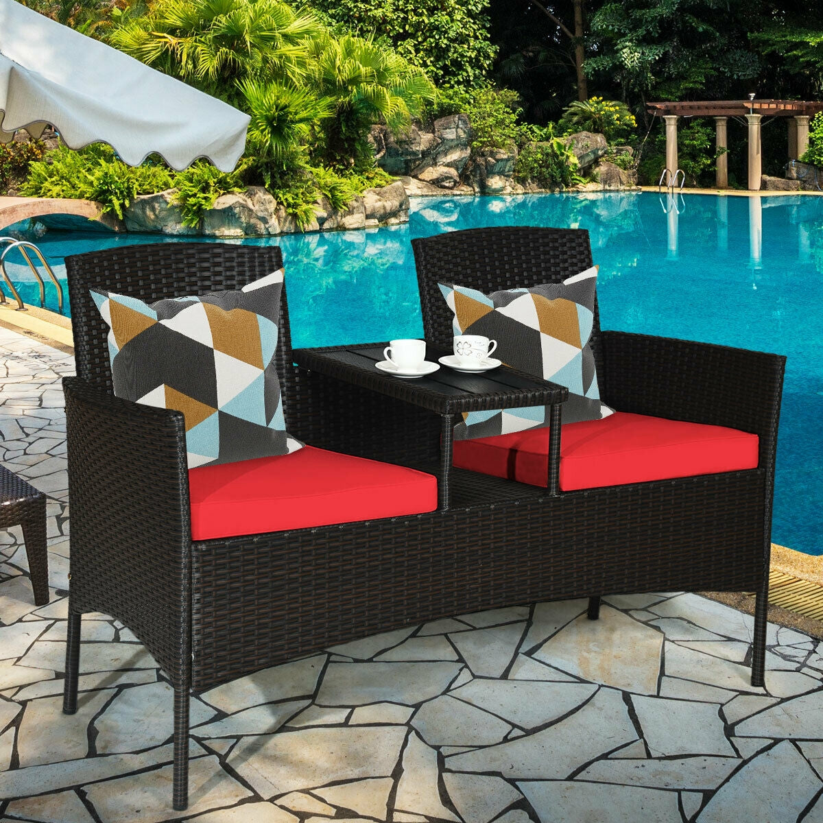Modern 2-Piece Patio Conversation Set with Built-in Coffee Table & Thick Cushions - Red, featuring stylish seating by a pool, accented with colorful pillows and a coffee table.