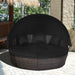 Black Rattan Round Daybed featuring a retractable canopy and an adjustable table, perfect for outdoor relaxation.