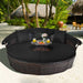 Black Rattan Round Daybed with Retractable Canopy, Adjustable Table & 3-Piece Seating Arrangement set outdoors with plush cushions and a fruit platter.