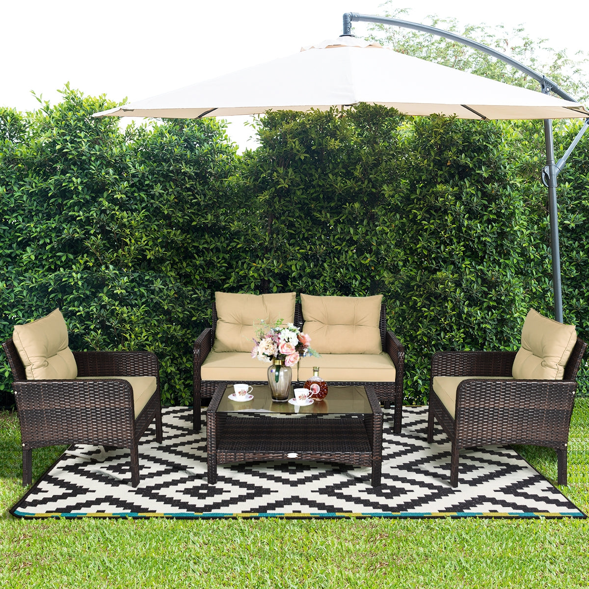 4-Piece Outdoor Rattan Furniture Set with Cushions showcased in a garden setting with an umbrella, complete with drinks and flowers.