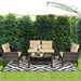 4-Piece Outdoor Rattan Furniture Set with Cushions showcased in a garden setting with an umbrella, complete with drinks and flowers.