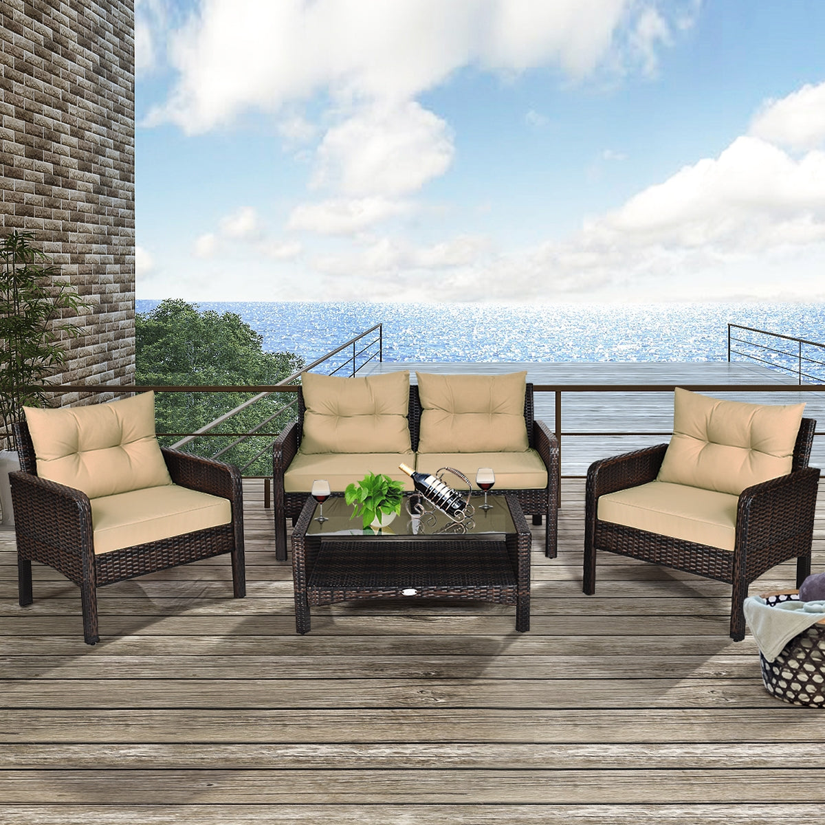4-Piece Outdoor Rattan Furniture Set with Cushions, Loveseat, 2 Single Sofas & Coffee Table arranged on a stylish deck overlooking a beautiful view of the sea.