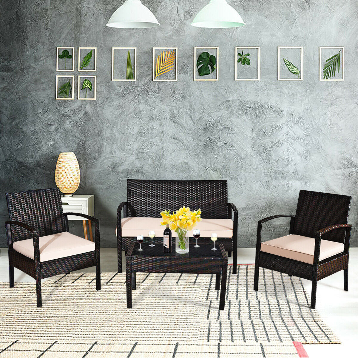 4-Piece Outdoor Patio Rattan Conversation Set with Loveseat, 2 Single Sofas & Glass Table arranged in a stylish indoor setting, featuring cushions and decorative items.